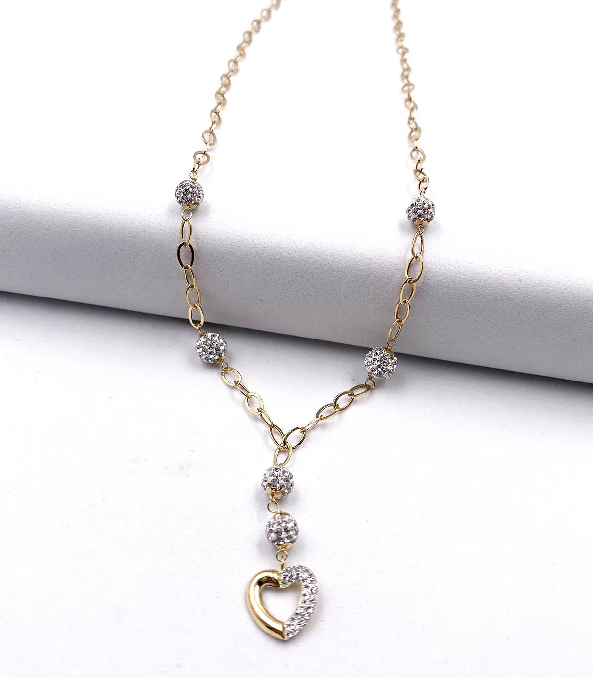 Collana in oro giallo con sfere e cuore di swarosky