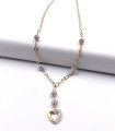 Collana in oro giallo con sfere e cuore di swarosky