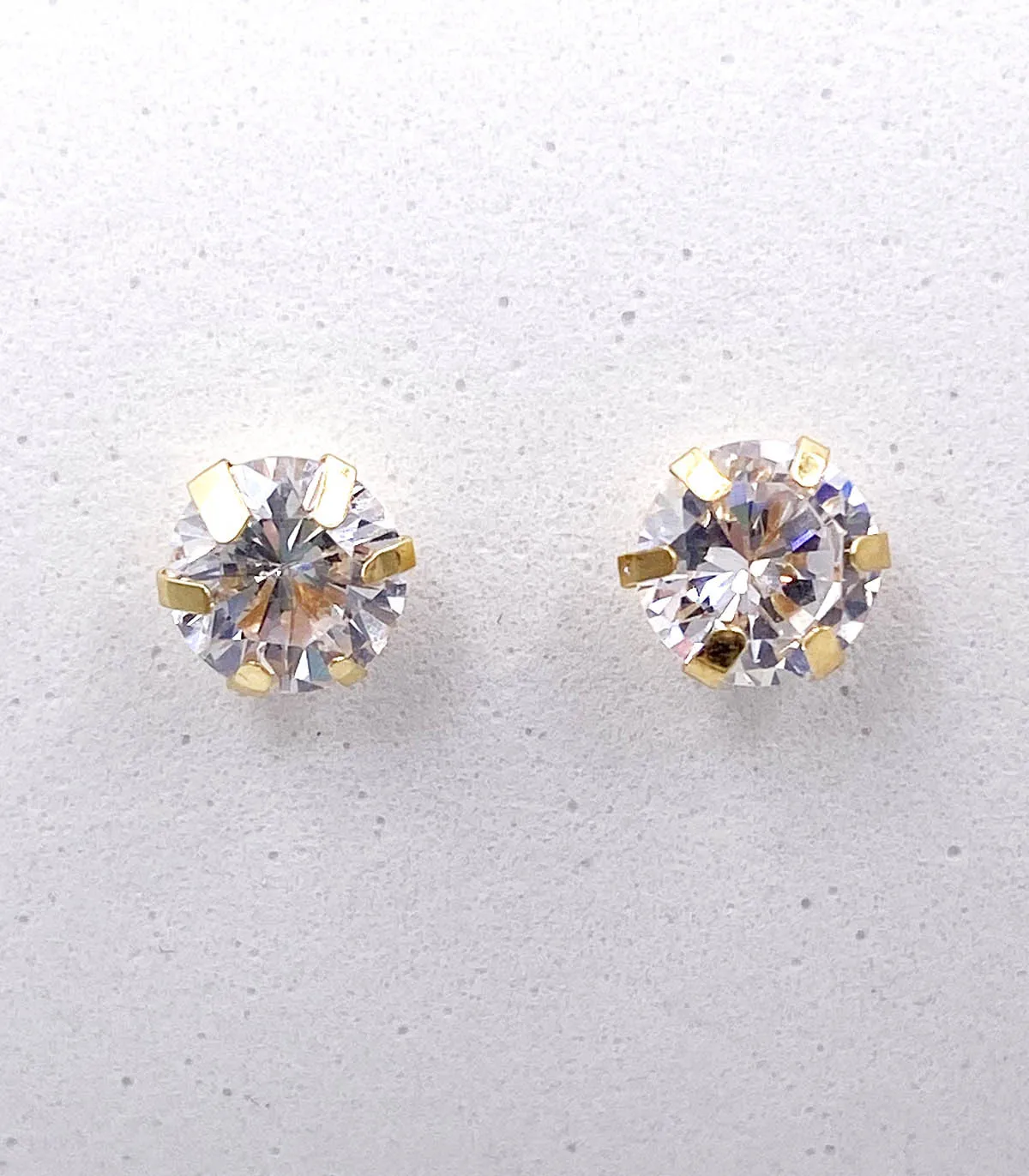 Orecchini punto luce in oro giallo con zirconi