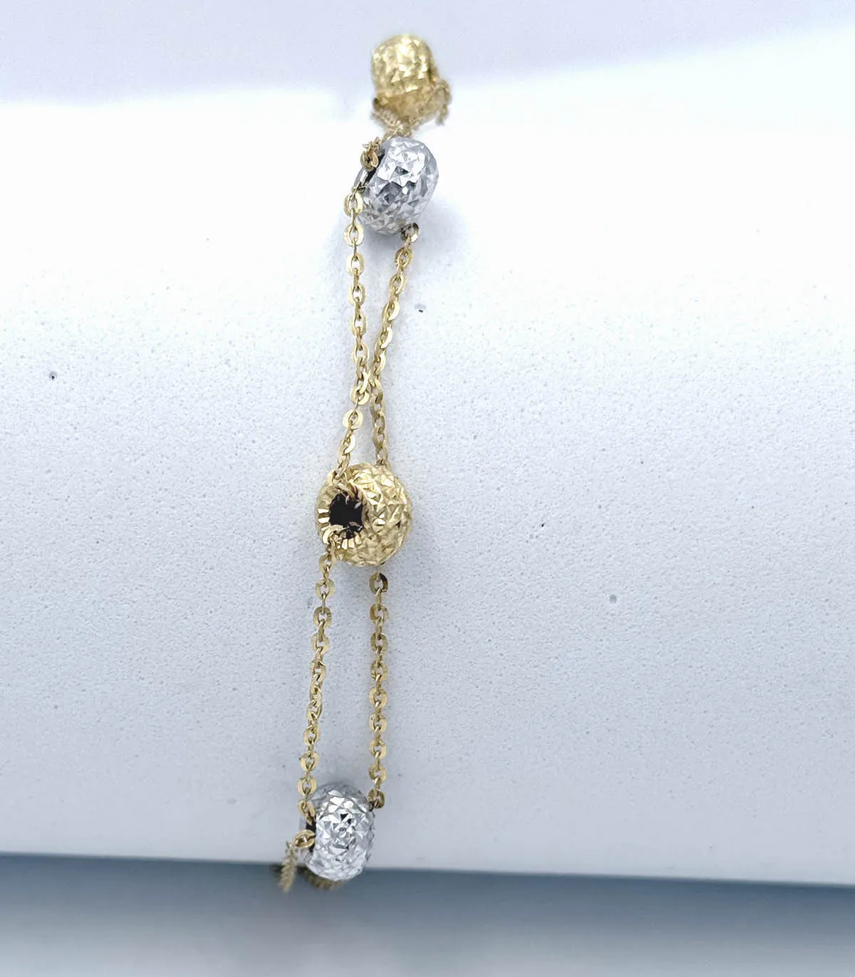 Bracciale multifili in oro giallo con bussolotti in oro giallo e oro bianco