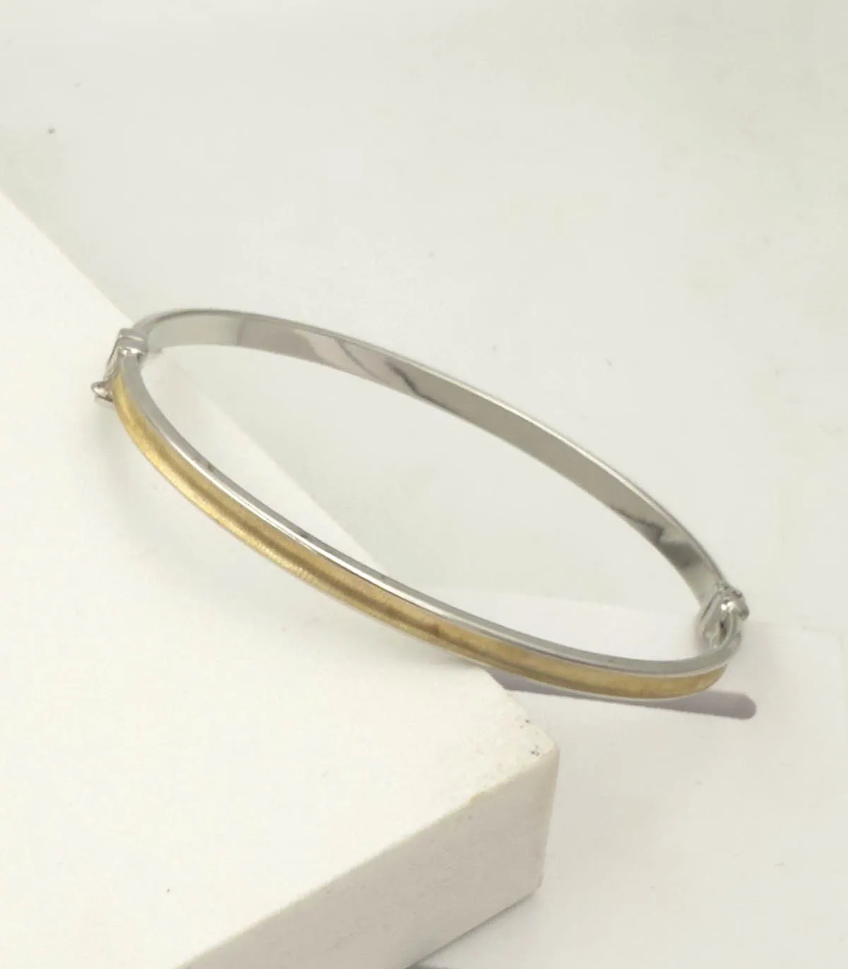 Bracciale rigido in oro bianco e oro giallo