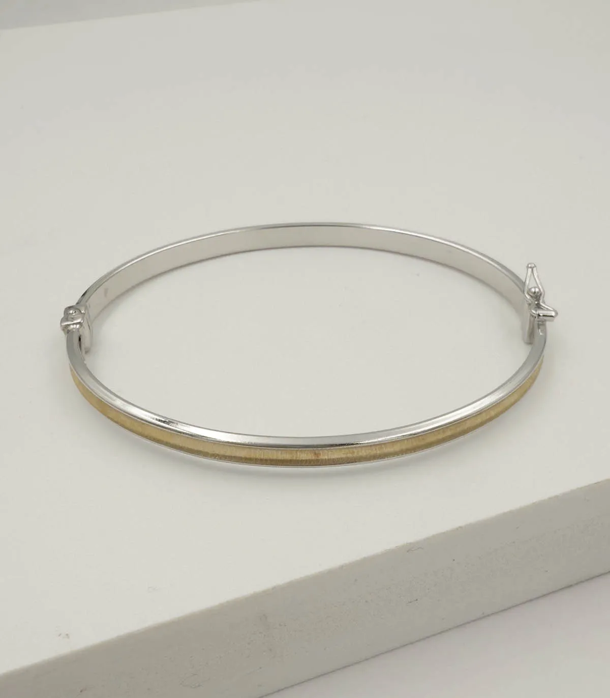 Bracciale rigido in oro bianco e oro giallo