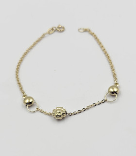 Bracciale in oro giallo con due sfere e fiore centrale